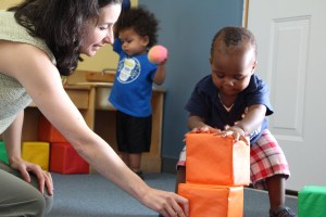 ECE and Boy Building with Blocks